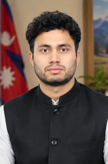 Prakash Nepali beside the flag of Nepal